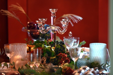 Christmas dining table fully dressed with decorations and foliage.の写真素材