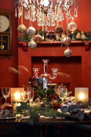 Christmas dining table fully dressed with decorations and foliage.の写真素材