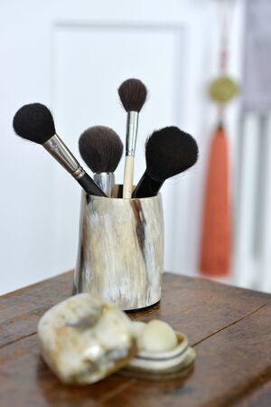 Makeup brushes in a horn container, luxury bathroomの写真素材