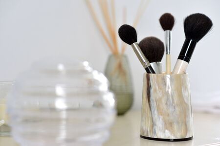 Makeup brushes in a horn container, luxury bathroomの写真素材