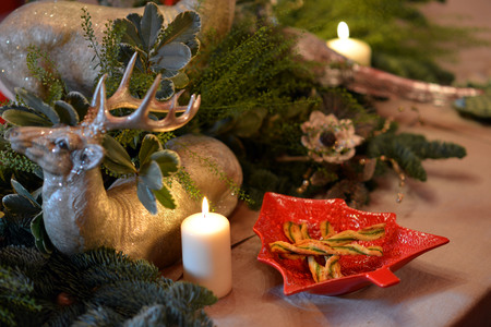 Decorated Christmas table with animal figures and colorful platesの写真素材