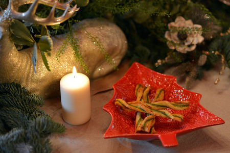 Decorated Christmas table with animal figures and colorful platesの写真素材
