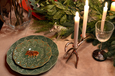 Decorated Christmas table with animal figures and colorful platesの写真素材