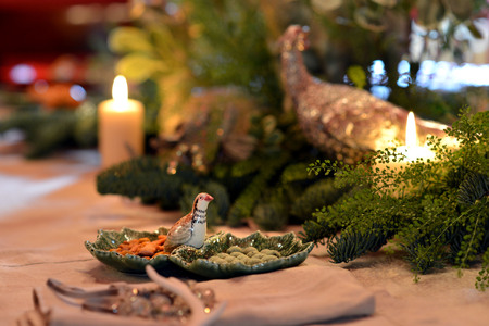 Decorated Christmas table with animal figures and colorful platesの写真素材