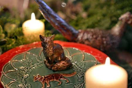 Decorated Christmas table with animal figures and colorful platesの写真素材