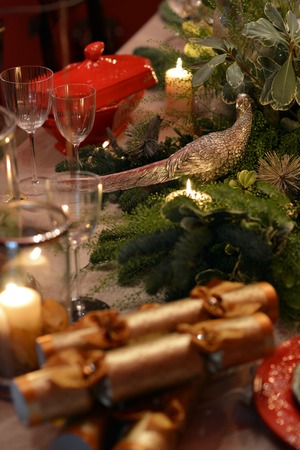 Decorated Christmas table with animal figures and colorful platesの写真素材
