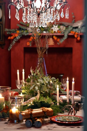 Decorated Christmas table with animal figures and colorful platesの写真素材