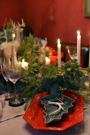 Decorated Christmas table with animal figures and colorful platesの写真素材