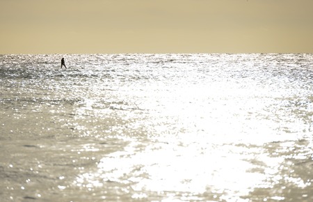 Jetsurfer using powered surfboard on a calm seaの写真素材