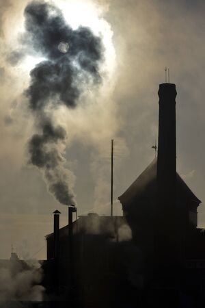 Steam rising from an old brewery chimney stackの写真素材