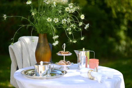 Alfresco coffee from silver coffee pot on linenの写真素材