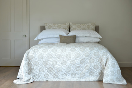 Bedroom setting with luxury pillows, shams and duvetsの写真素材