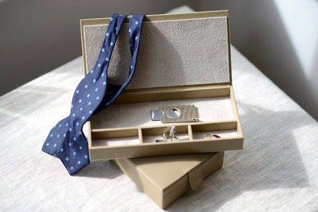 Brown leather box with bow tie cigar cutter and cufflinksの写真素材