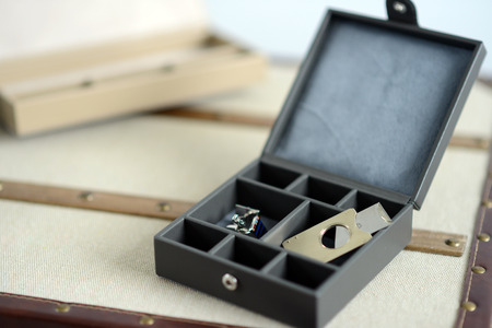 Brown leather box with bow tie cigar cutter and cufflinksの写真素材