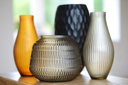 Group of four decorative cut glass vases in a roomの写真素材