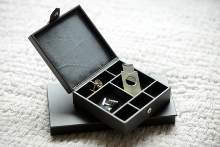 Brown leather box with bow tie cigar cutter and cufflinksの写真素材