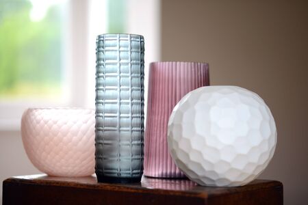 Group of four decorative cut glass vases in a roomの写真素材