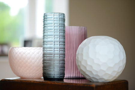 Group of four decorative cut glass vases in a roomの写真素材