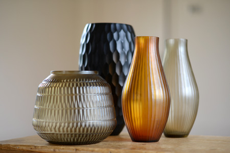 Group of four decorative cut glass vases in a roomの写真素材