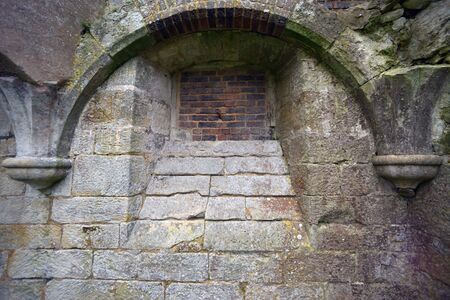 Remains of a ruined Tudor building showing windows and doorsの写真素材