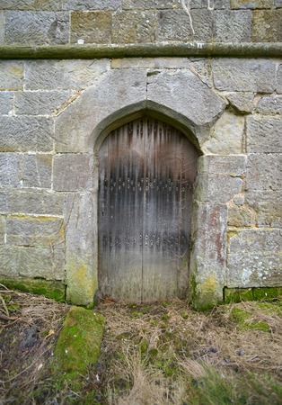 Ancient oak door in a stone built towerの写真素材