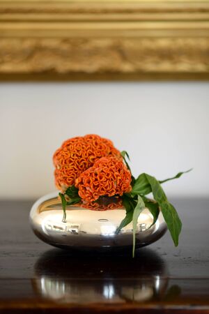 Flowers displayed in a silver vase insideの写真素材
