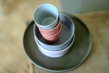 Stack of ceramic bowls and cups insideの写真素材