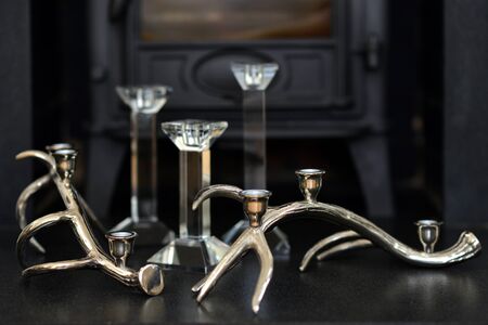 Silver deer antler candle sticks in a fire placeの写真素材