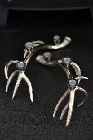 Silver deer antler candle sticks in a fire placeの写真素材