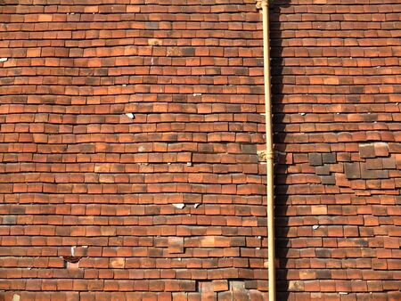 Old tile hung wall with some loose tilesの写真素材