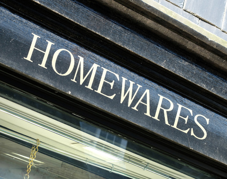 Painted white homewares sign on black backgroundの写真素材