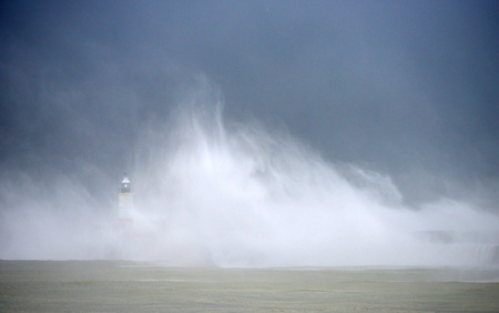 Huge waves striking Newhaven breakwater, UK, during a winter stormの写真素材