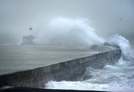 Huge waves striking Newhaven breakwater, UK, during a winter stormの写真素材