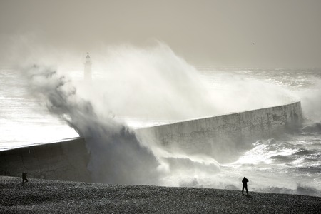 Huge waves striking Newhaven breakwater, UK, during a winter stormの写真素材