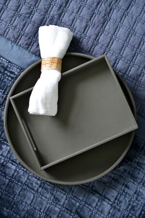 Dark brown leather tray in a blue bedroomの写真素材