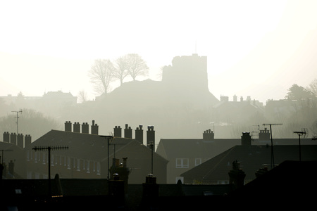 Historic Lewes Castle in layers of mist, with rooftopsの写真素材