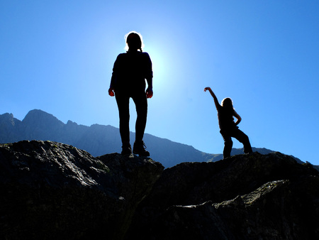 Teen girls standing on rocky outcrops in the fells of the English Lake Districtの写真素材