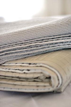 Folded textured quits and throws in neutral earth tones
