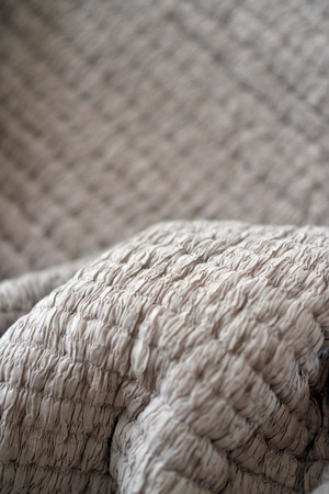 Quilted textured grey soft bedding materialの写真素材