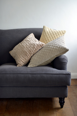 Selection of different cushions on a grey couchの写真素材