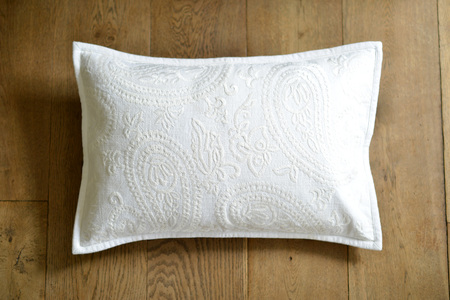 Individual textured cushion on a wooden backgroundの写真素材