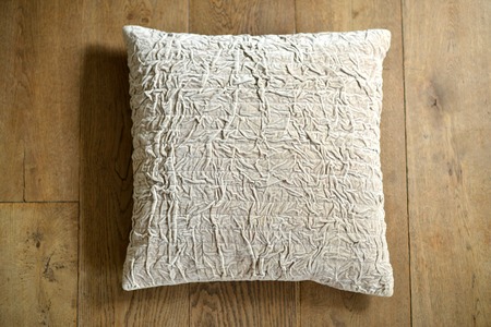 Individual textured cushion on a wooden backgroundの写真素材