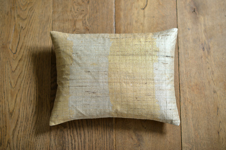 Individual textured cushion on a wooden backgroundの写真素材