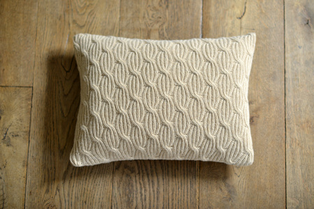 Individual textured cushion on a wooden backgroundの写真素材