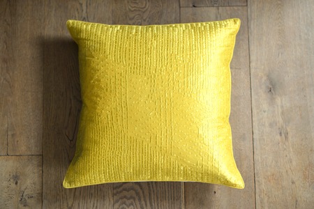 Individual textured cushion on a wooden backgroundの写真素材