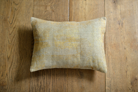 Individual textured cushion on a wooden backgroundの写真素材