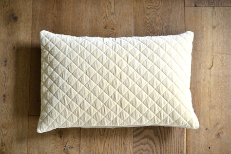 Individual textured cushion on a wooden backgroundの写真素材