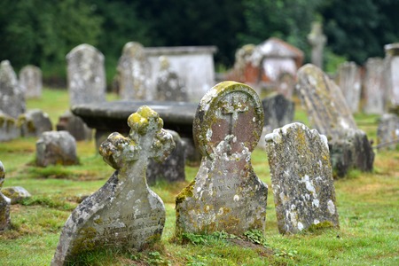 Old gravestones in a small village churchyardの写真素材
