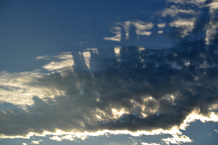 Unusual cloud patterns and shadows in the evening skyの写真素材