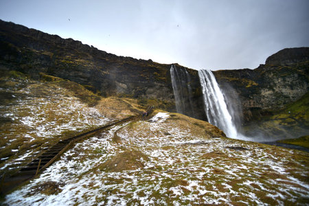 Seljalandsfoss waterfall with snow in mid winter, Icelandの写真素材